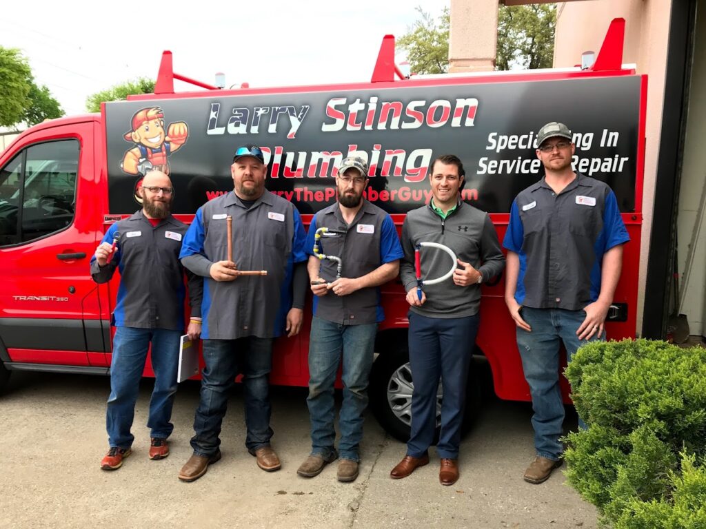 Larry Stinson Plumbing team in front of red van.