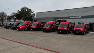 Plumbing company vans parked at business location.